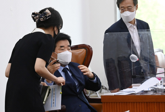 김진표 민주당 부동산특위 위원장이 8일 국회에서 열린 공청회에 앞서 관계자와 대화하고 있다. 연합뉴스